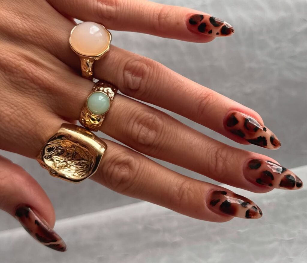 THE MANICURE WORLD IS GETTING FERAL WITH ANIMAL PRINT NAILS TRENDING HARD .